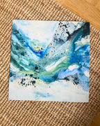 Abstract art print by Mette Lindberg – fluid blue, teal and green tones on white background, square format