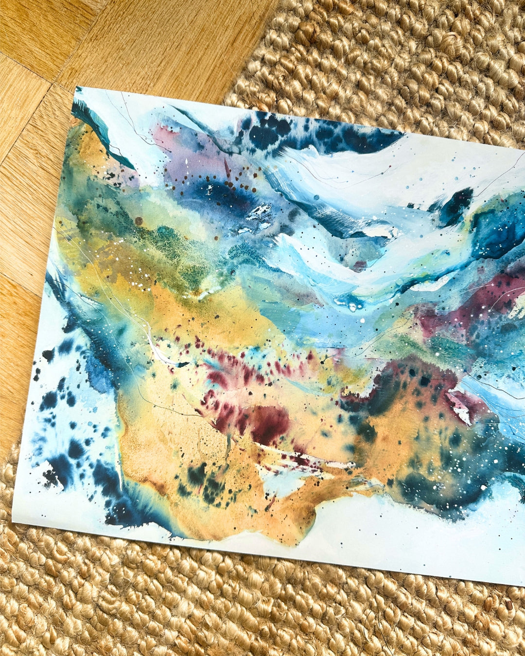 Abstract art print on cotton paper by Mette Lindberg – fluid blue, ochre, teal and burgundy tones with ink splatter