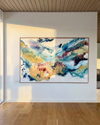 Large abstract painting on canvas in blue, teal, gold and purple tones with oak frame, displayed in a bright Nordic home with oak wood flooring and slatted ceiling