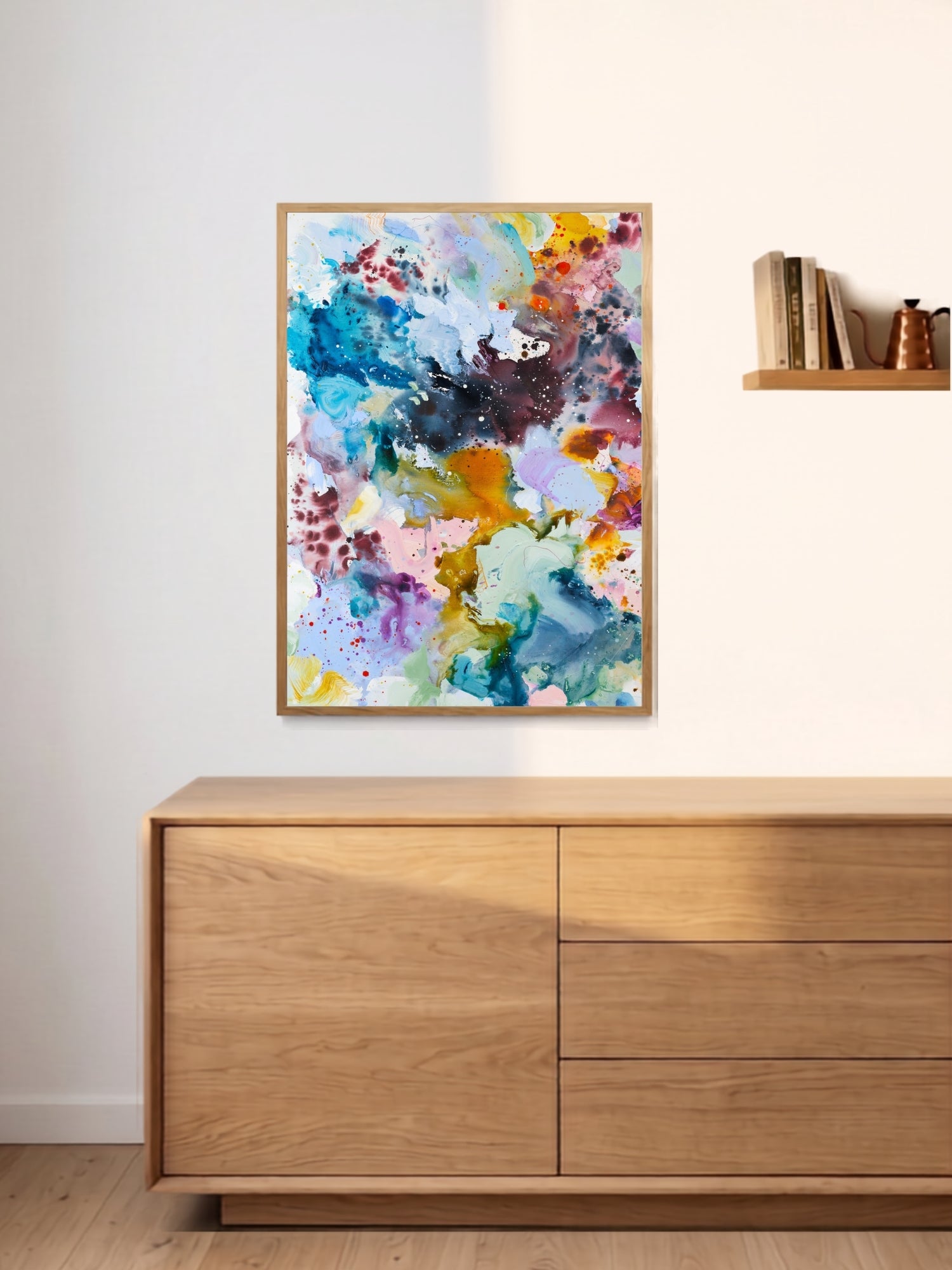 colourful-abstract-art-print-oak-cabinet.jpg Colourful abstract art print displayed above oak cabinet – interior styling by Mette Lindberg