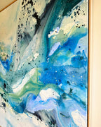 Corner detail of large original abstract canvas painting in natural oak float frame – expressive brushwork in teal, cobalt blue, sage green and white with black and white paint splatter and glitter details
