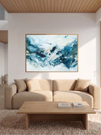 Large abstract blue art print displayed above white sofa – modern artwork in nordic style
