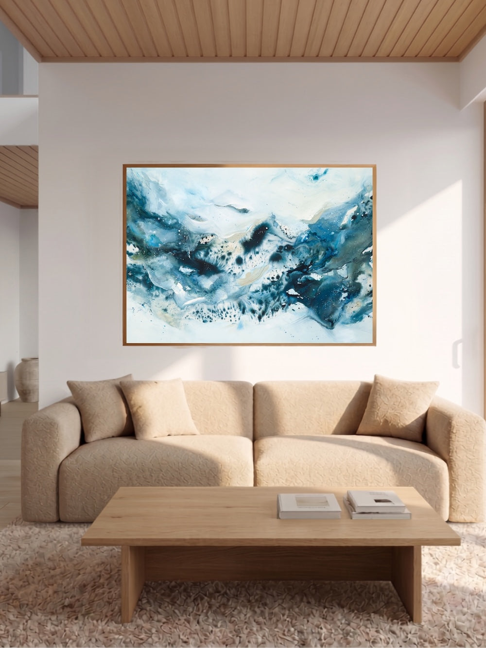 Large abstract blue art print displayed above white sofa – modern artwork in nordic style