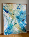 Large unique abstract wall art on canvas in oak frame. Vibrant splashes of teal, cobalt blue and golden tones by Danish fine artist Mette Lindberg. Original handmade painting, 100x150 cm.