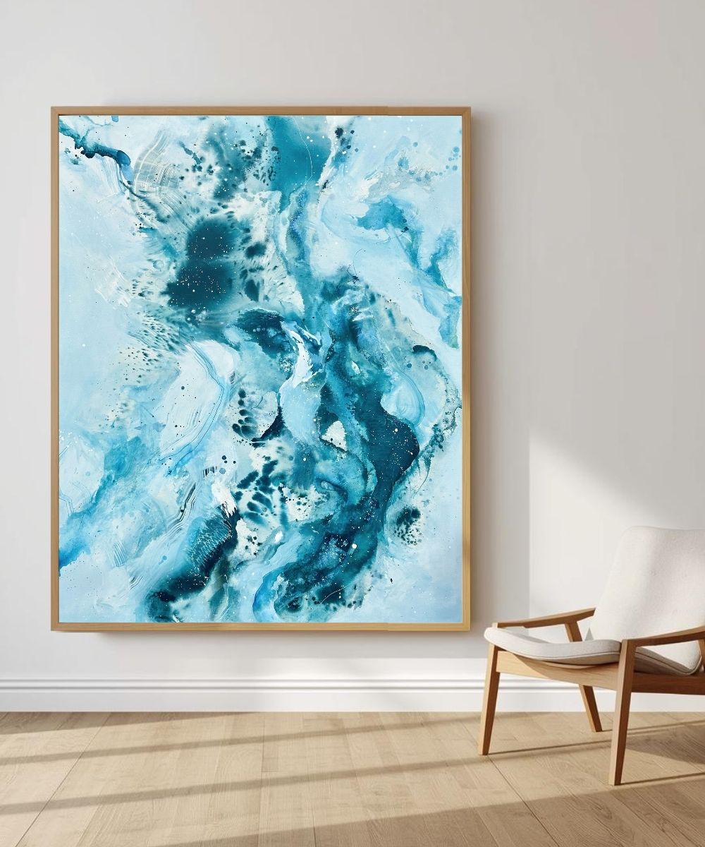 Soft #14 – large original abstract canvas painting, 120x150 cm, in natural oak frame. Expressive fluid blue and teal waves by Danish artist Mette Lindberg, shown in Scandinavian interior setting